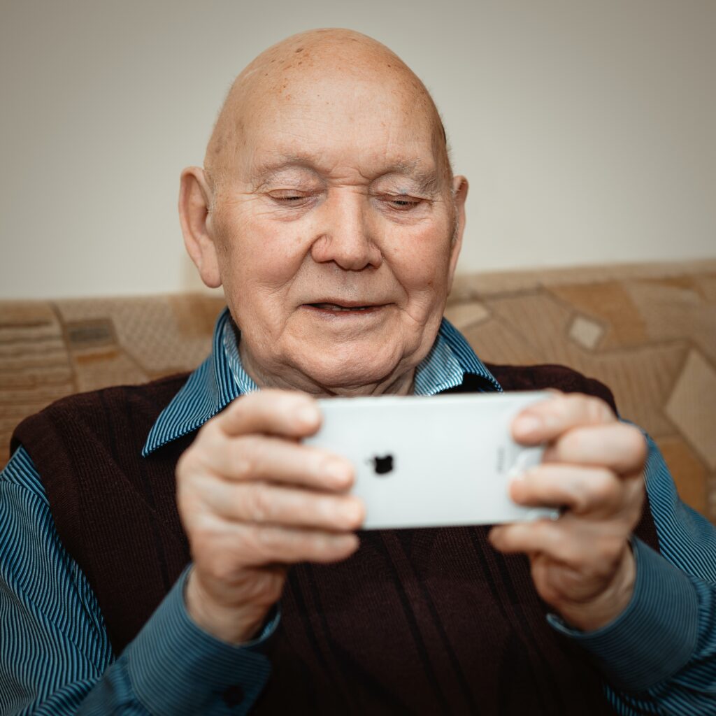 Elderly man with a phone in his hand using security specialists solutions