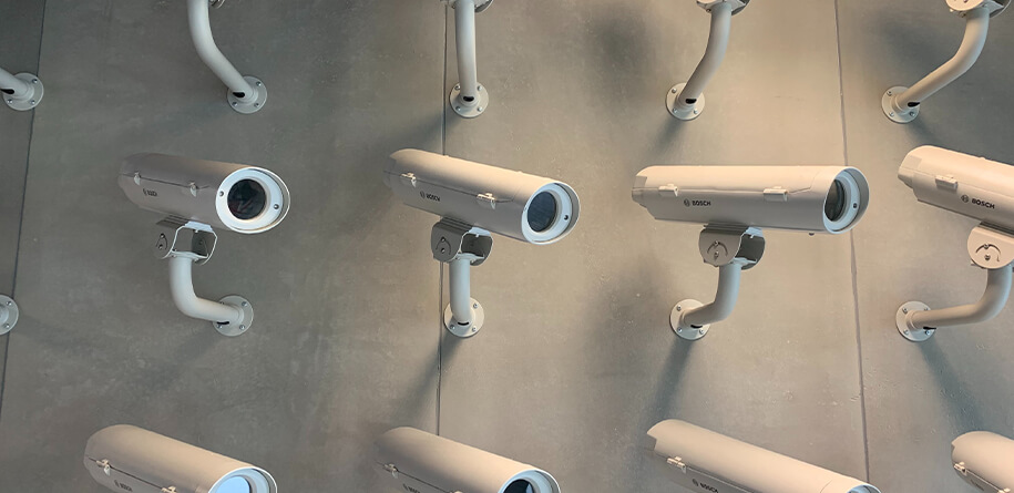 White color security cameras placed on concrete wall